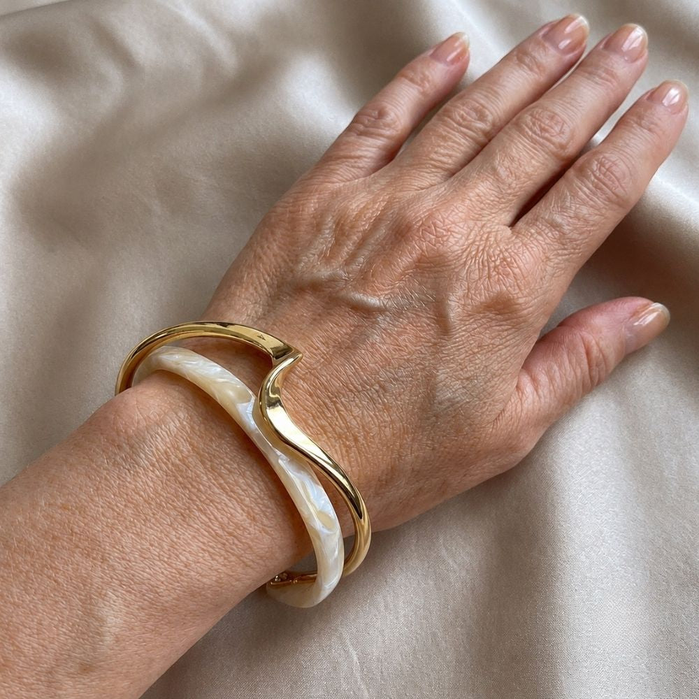 Hvidskær | Guldfarvet bangle med hvid detalje og opallignende skær – Visning 02