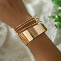 Guldstabel | Bred guldfarvet bangle – Visning 01