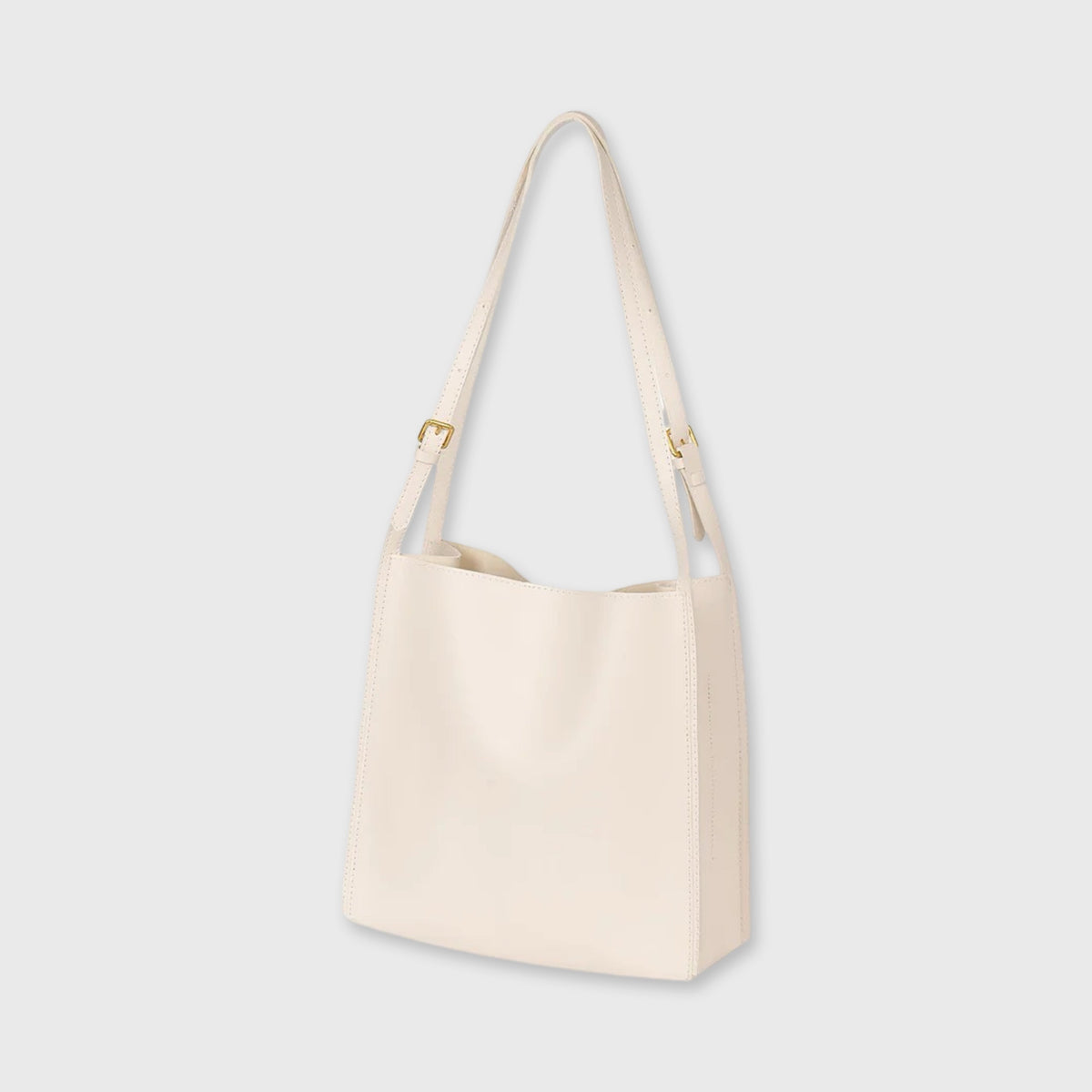Creme Tote skuldertaske set fra siden